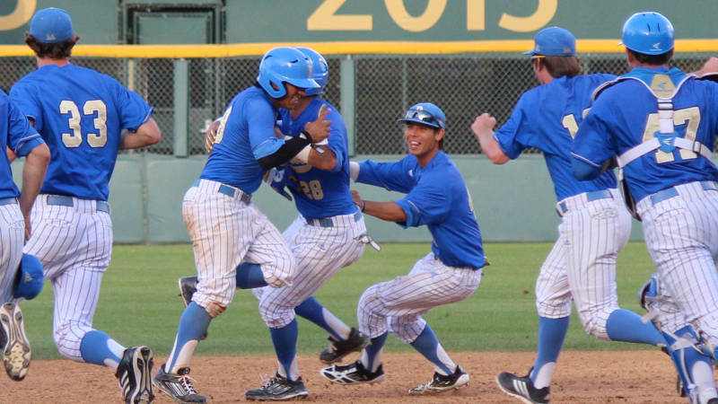 Trent Chatterton swarmed after walk-off sac fly. Photo by Andy Berg courtesy UCLA Athletics